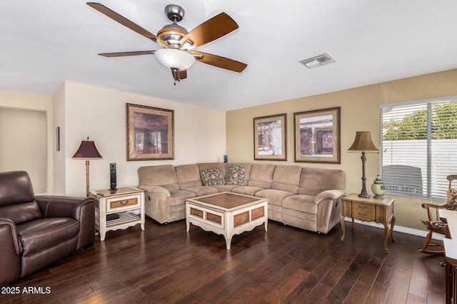 living room with dark hardwood / wood-style flooring and ceiling fan