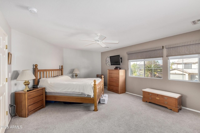 bedroom with ceiling fan and light carpet