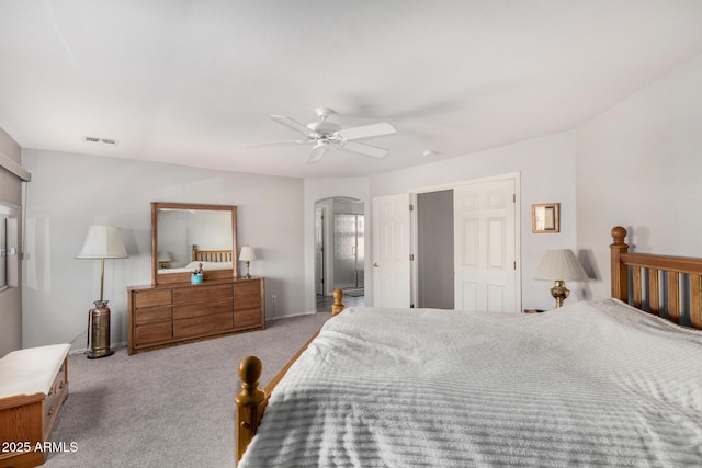 bedroom with ceiling fan and light carpet