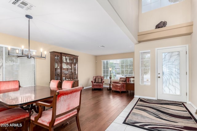 dining room featuring hardwood / wood-style floors and a chandelier