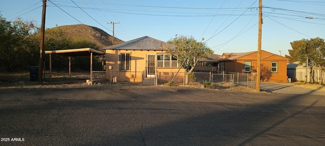 bungalow-style house with fence, a gate, a mountain view, and a carport