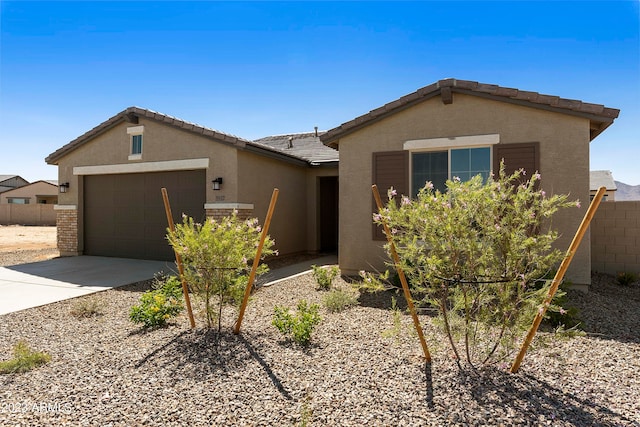 ranch-style home featuring a garage