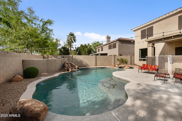 view of swimming pool featuring a fenced backyard, a fenced in pool, and a patio