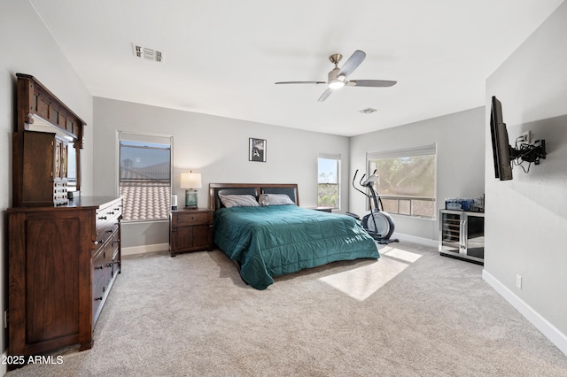 bedroom with baseboards, visible vents, and light colored carpet