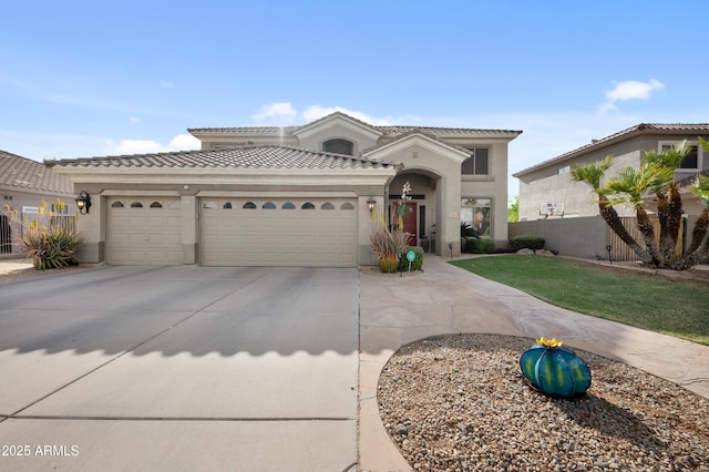 mediterranean / spanish house with stucco siding, driveway, a garage, and a tiled roof