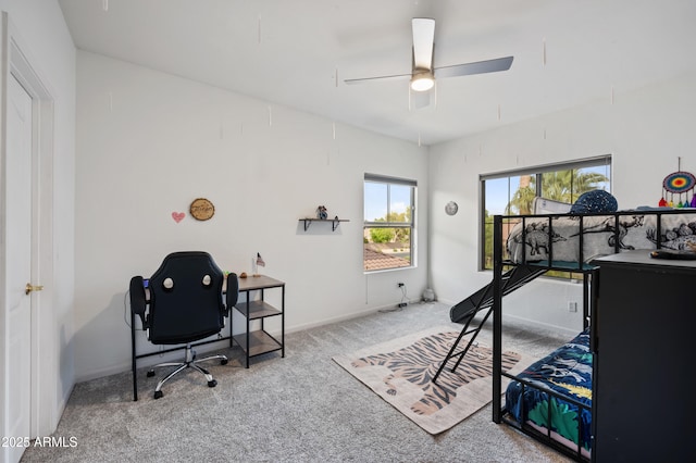 carpeted bedroom with a ceiling fan and baseboards