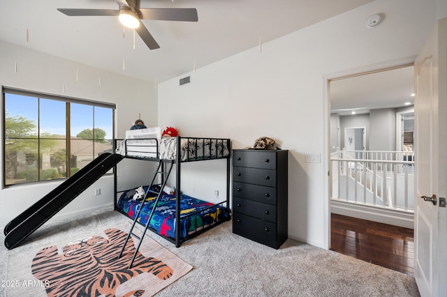 carpeted bedroom featuring ceiling fan and visible vents