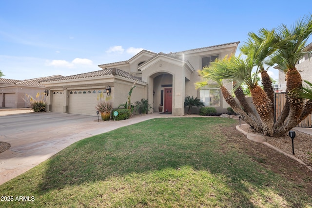 mediterranean / spanish house featuring a tile roof, concrete driveway, stucco siding, a front lawn, and a garage