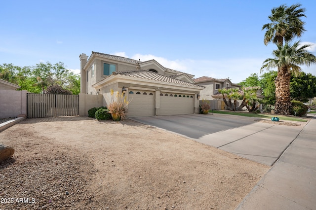 view of front of property with stucco siding, a gate, a garage, and concrete driveway