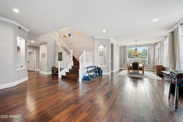 living room with ornamental molding, hardwood / wood-style flooring, baseboards, and stairs