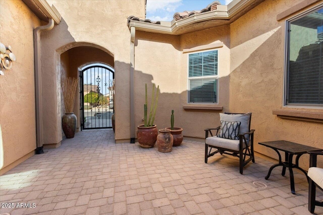 view of exterior entry featuring a patio area