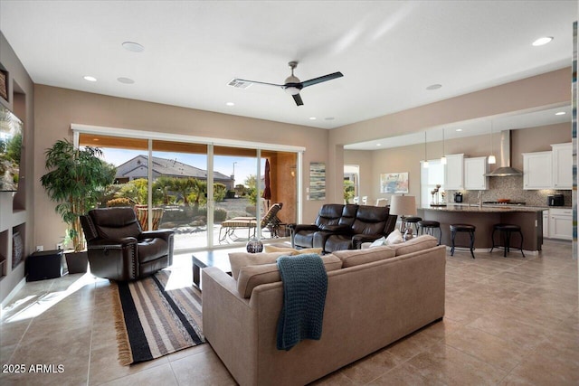 tiled living room featuring ceiling fan