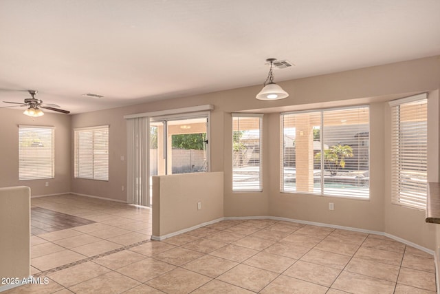 empty room featuring light tile patterned flooring and ceiling fan