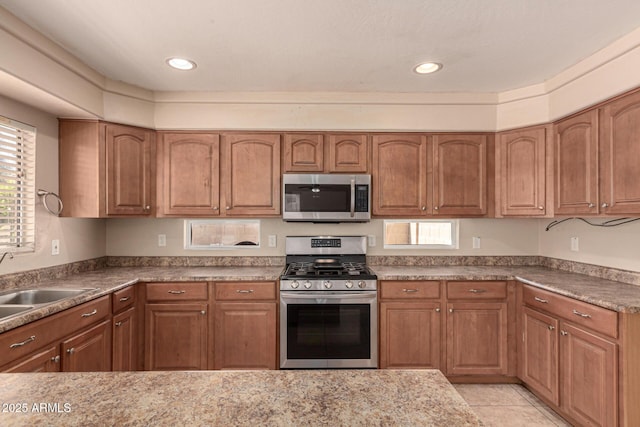 kitchen featuring sink, light tile patterned flooring, and appliances with stainless steel finishes