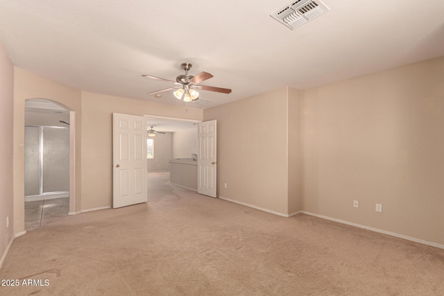 unfurnished bedroom featuring light carpet and ceiling fan