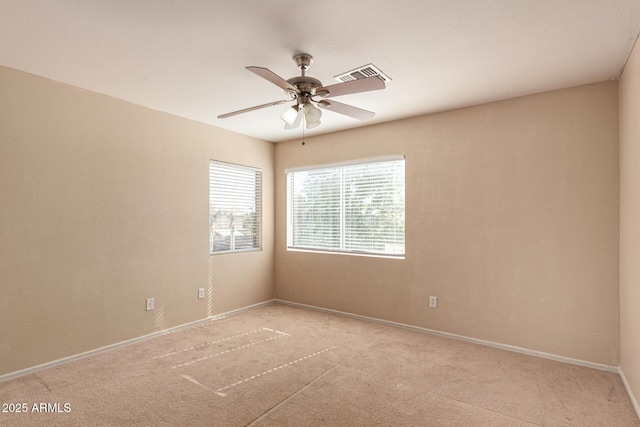 carpeted empty room featuring ceiling fan