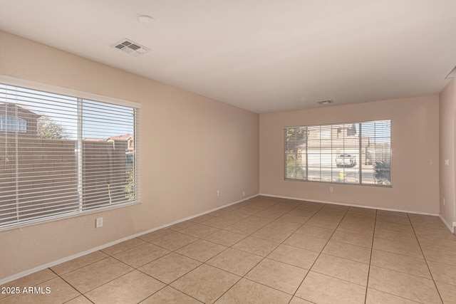 empty room with light tile patterned flooring