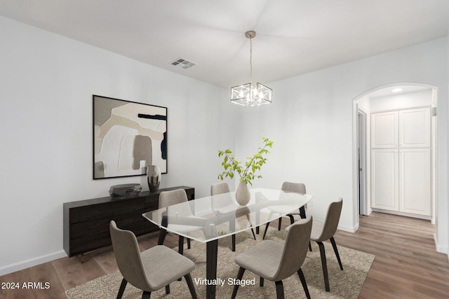 dining room featuring light hardwood / wood-style floors and a chandelier