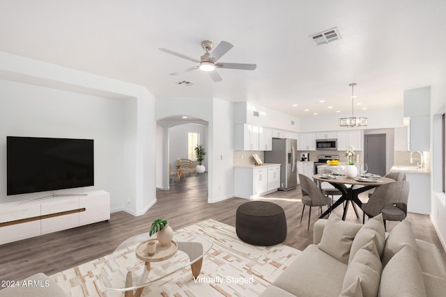 living room with hardwood / wood-style floors and ceiling fan