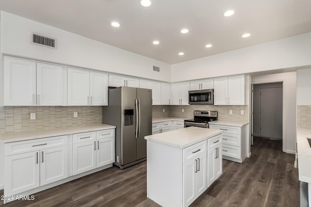 kitchen featuring white cabinets, dark hardwood / wood-style flooring, and appliances with stainless steel finishes