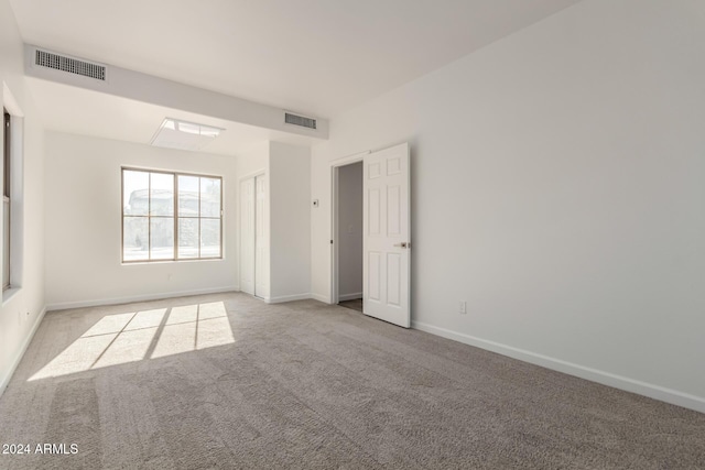 empty room featuring light colored carpet