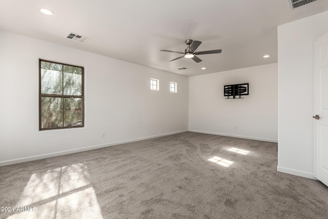 empty room with ceiling fan and carpet floors