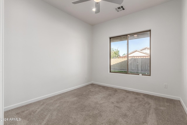 carpeted spare room with ceiling fan