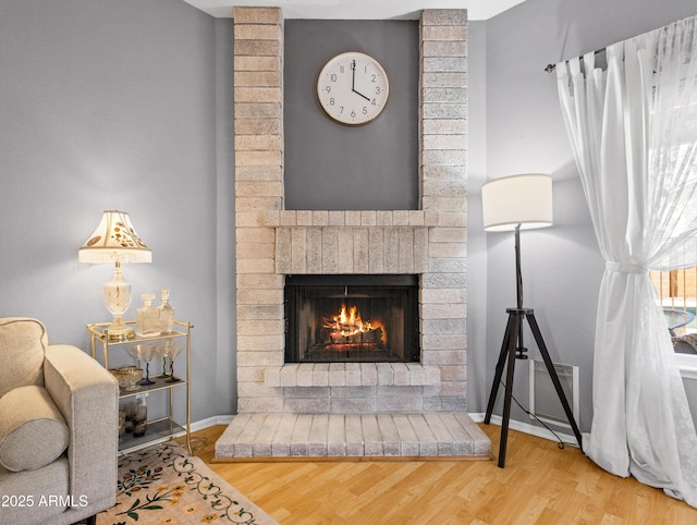 7726 W Cameron Dr, Peoria, AZ 85345 - living area with a brick fireplace, baseboards, and wood finished floors