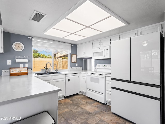 7726 W Cameron Dr, Peoria, AZ 85345 - kitchen with visible vents, white cabinets, a sink, stone finish floor, and white appliances