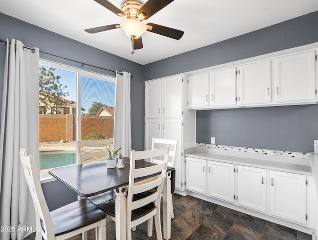 7726 W Cameron Dr, Peoria, AZ 85345 - dining space with stone finish floor and ceiling fan