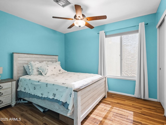 7726 W Cameron Dr, Peoria, AZ 85345 - bedroom featuring ceiling fan, visible vents, baseboards, and wood finished floors