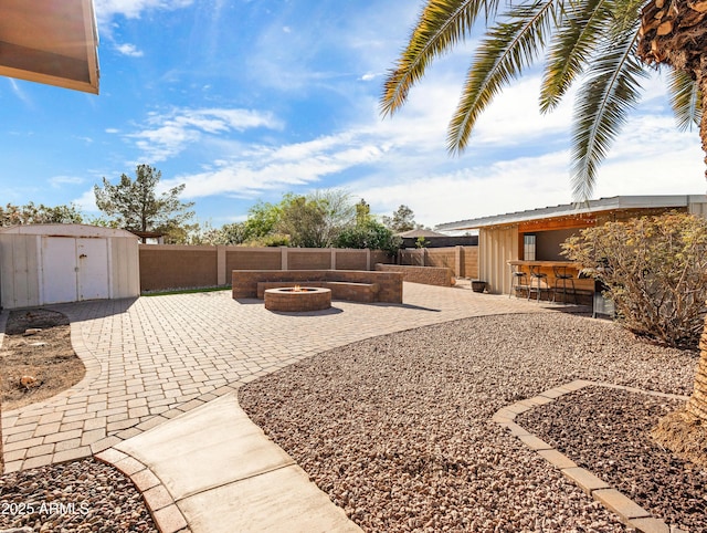 7726 W Cameron Dr, Peoria, AZ 85345 - view of yard with a patio, outdoor dry bar, an outdoor fire pit, an outbuilding, and a storage unit
