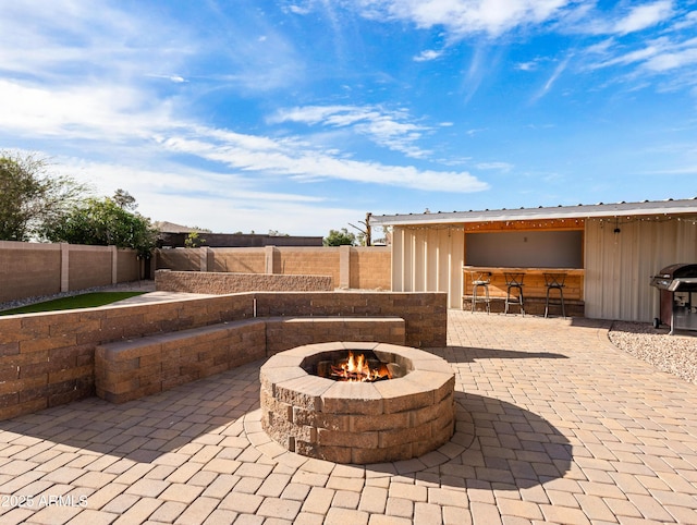7726 W Cameron Dr, Peoria, AZ 85345 - view of patio featuring grilling area, a fenced backyard, and a fire pit