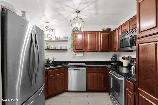 kitchen with light tile patterned flooring, stainless steel appliances, a textured ceiling, sink, and a chandelier