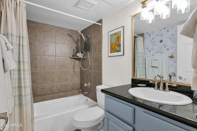 full bathroom featuring vanity, a textured ceiling, toilet, and shower / tub combo