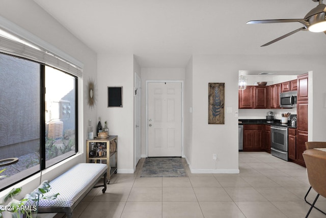 tiled entryway featuring plenty of natural light and ceiling fan