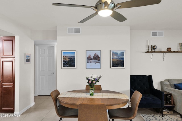 tiled dining space featuring ceiling fan