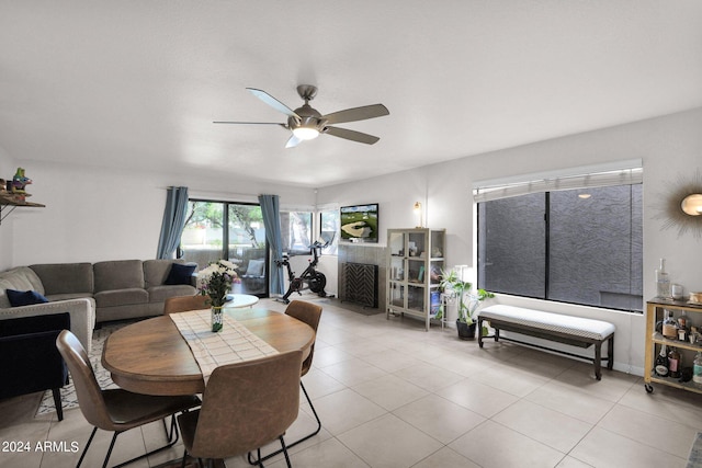 tiled dining space with ceiling fan