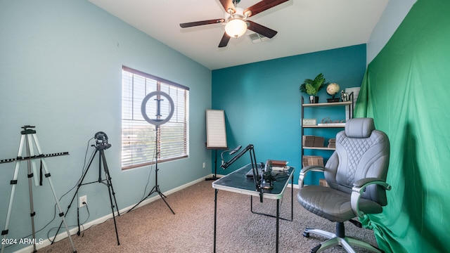 carpeted office featuring ceiling fan