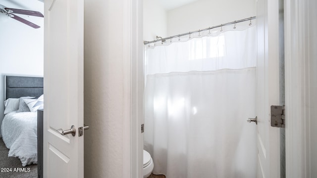 bathroom featuring toilet and a shower with shower curtain