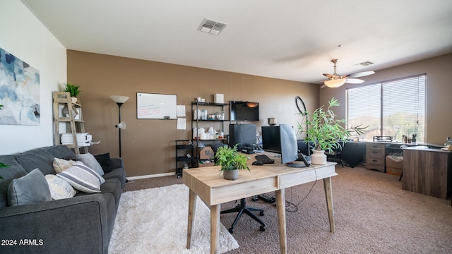 carpeted home office with ceiling fan