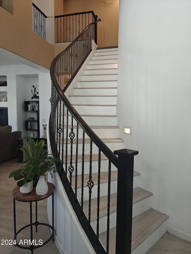 stairway with hardwood / wood-style flooring