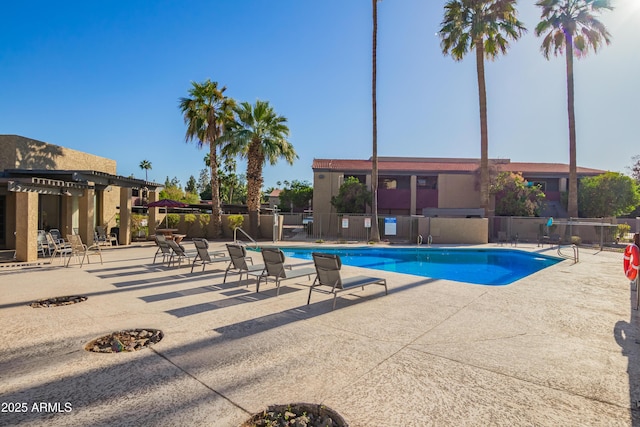pool featuring fence and a patio