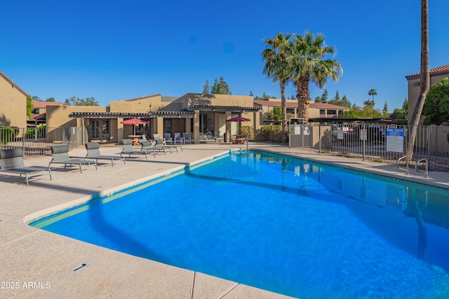 community pool featuring a patio area and fence