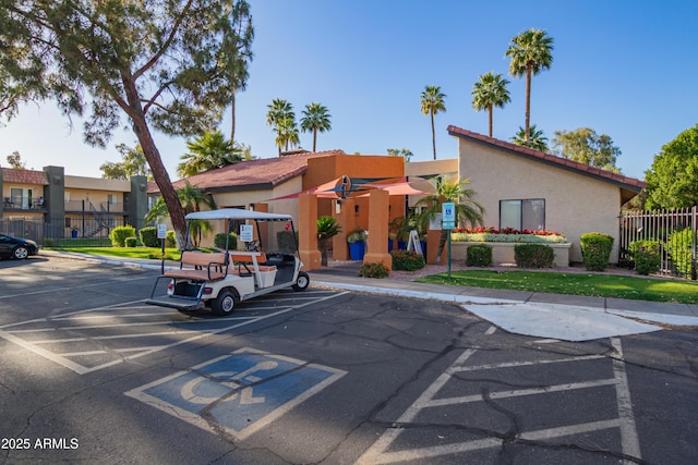 view of property featuring fence and uncovered parking