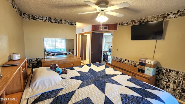 bedroom with ceiling fan, a closet, and a textured ceiling