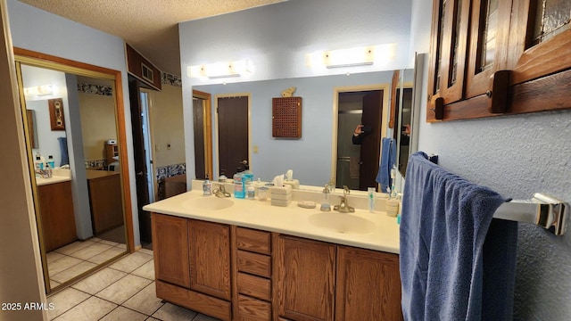 bathroom with vanity, tile patterned flooring, and a textured ceiling