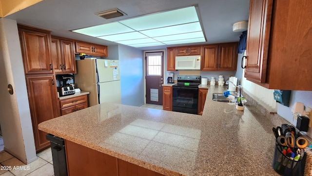 kitchen featuring sink, white appliances, kitchen peninsula, and light tile patterned flooring