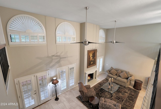 living room featuring light wood-type flooring, a wealth of natural light, and ceiling fan