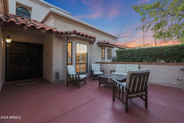 patio terrace at dusk featuring an outdoor hangout area